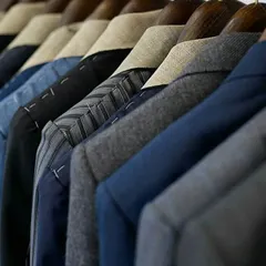 A rack of our bespoke creations in progress. Each piece is meticulously crafted, waiting to be delivered to a discerning client.