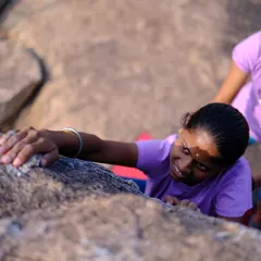 A close-up of one of the young girls from the village trying climbing for the first time, with a CLAW member spotting her. It was amazing to see their pure joy and excitement.