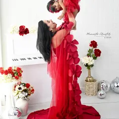 Pure joy in a single moment. I love capturing the dynamic connection between a mother and her child, and this playful lift, with both in stunning matching red gowns, is a perfect example of that beautiful energy.