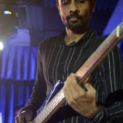 Our instructor Dhawal playing bass guitar on stage with the students at our annual showcase at The Finch.
