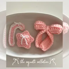 My "coquette collection" for the holidays, featuring a pink candy cane, a star with a tiny bow, and a signature large bow, all in a cute pink and white theme.