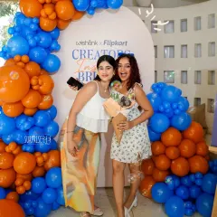 Guests enjoying the photo-op at the Wishlink x Flipkart event. The bold balloon arch in the brand's colors provided the perfect backdrop for creators to capture content.
