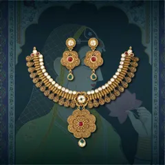 This antique-style necklace set features intricate floral motifs and is studded with red and green stones, offering a touch of royal elegance.