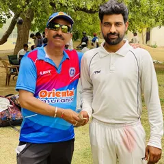 A senior player with a club official on the field. The support from our club management and seniors is crucial to the team's morale and success.