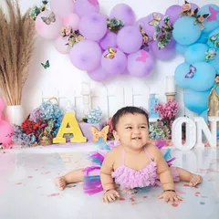 The happiest little butterfly. This colorful first birthday shoot is full of smiles, with a beautiful balloon arch and a playful, celebratory atmosphere.