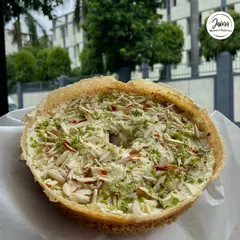 A close-up of our authentic Malai Ghewar, generously topped with sliced almonds and pistachios. It's the perfect indulgence for the festive feeling of Sawan and Teej.
