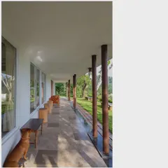 The long, covered verandah is a key feature of this home, providing a shaded space to enjoy the views and climate. It seamlessly connects the interior living spaces with the natural landscape outside.