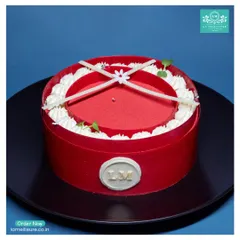 This striking Red Velvet entremet cake is designed to impress. Its bold red exterior, delicate white chocolate details, and our signature 'LM' seal make it a perfect centrepiece.