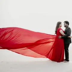 A simple background is all you need when you have a gown this dramatic. This red long-tail gown creates a powerful and romantic statement for any pre-wedding or maternity shoot.