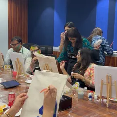 Guiding a participant as she begins her tote bag design. We provide stencils and ideas, but everyone is free to create their own unique masterpiece.