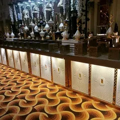 For large-scale weddings and corporate galas, I create stunning, illuminated counter setups like this one. The combination of sophisticated lighting, elegant decor, and a vast food display makes for a truly grand impression.