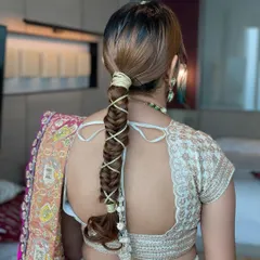 A detailed view of the gotta string braid. This technique keeps the hair neatly tied back while adding a stunning, intricate detail.