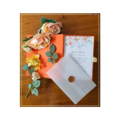 We design luxury boxed invitations for all of life's special occasions. This vibrant orange box, featuring delicate gold-foiled floral line art, was created for a naming ceremony and includes a vellum-wrapped insert with a wax seal.