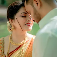 A tender moment between the couple, their foreheads touching in a gesture of deep affection and intimacy.