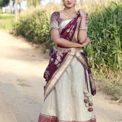 For a timeless South Indian look, I offer this beautiful Langa Voni, or half saree. The elegant combination of cream and deep purple silk is perfect for weddings and festive events.