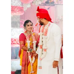 A sweet, candid moment between the bride and groom during their Maharashtrian wedding ceremony. Their shared smile speaks volumes about their happiness.