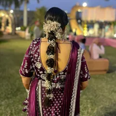 A beautiful floral braid for a wedding guest. This hairstyle combines a traditional braid with fresh baby's breath flowers for a romantic and elegant look.