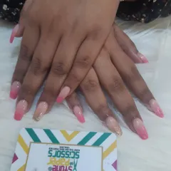 A classic pink ombre on long coffin-shaped nails. This set features a seamless blend from soft nude to a pretty pink, with one accent nail in a subtle gold glitter.