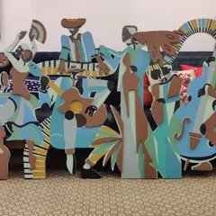 The 'Lost in the Rhythm' installation is a freestanding sculpture celebrating music and dance. Composed of colorful, layered wooden figures of musicians and dancers, it's a piece designed to bring joy and movement into a room.