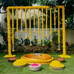 For this outdoor Haldi ceremony, I used traditional marigolds to create a vibrant and auspicious backdrop. The setup includes a central seating area and baskets of fresh petals, perfect for pre-wedding rituals and photos.