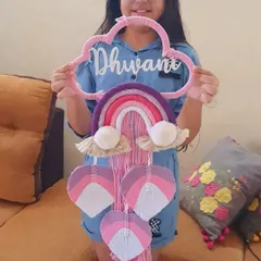 My lovely client Dhwani holding her custom nameplate. The pink and purple design looks so beautiful, and I'm so happy she loves it.