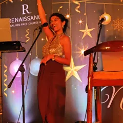 A joyful moment on stage during a Christmas celebration at the Renaissance Bengaluru. This is the kind of energy I bring to festive events, making sure everyone feels the celebratory spirit.