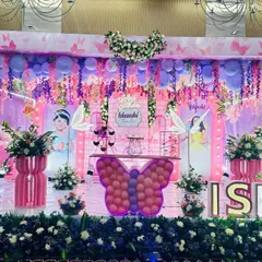 A closer view of the enchanted butterfly stage, highlighting the personalized backdrops and intricate details.