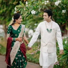 A candid moment of a couple walking hand-in-hand through a lush garden. Dressed in beautiful Maharashtrian attire, their shared glance speaks volumes, reflecting the natural, unscripted joy I love to capture.