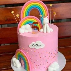This pretty pink unicorn and rainbow cake is one of our most requested designs. It features handmade fondant rainbows, clouds, and a cute unicorn, finished with colorful sprinkles for a touch of magic.
