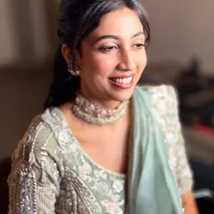 Another beautiful smile from Neha. The makeup is designed to look flawless from all angles, ensuring she looks perfect in every photo.