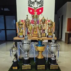 The rewards of dedication. Our trophy cabinet is a source of pride, showcasing the success our teams have achieved in various local and state-level football tournaments.