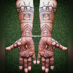 The same stunning bridal arm design set against a natural green backdrop.