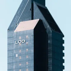 A close-up of the Lodha Altamount facade, highlighting the clean lines and reflective glass that define this luxury residential tower. The design emphasizes verticality and modernism, making it a prominent feature in its neighborhood.