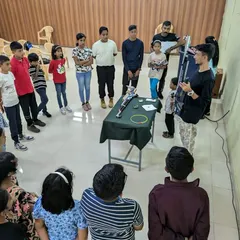 An overhead view of a safety and equipment demonstration for a group of students. Understanding the equipment is the first step to becoming a confident shooter.