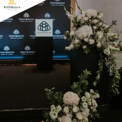 A close-up of the floral installations for the Maybach launch. We used a mix of white hydrangeas, roses, and gladiolus to create a cascading effect against the dark, branded pedestals, highlighting the contrast between soft elegance and bold design.