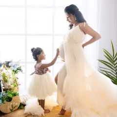A heartwarming family maternity photo where a big sister-to-be gently touches her mother's baby bump. This captures the sweet anticipation and growing love within the family.