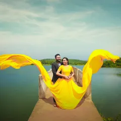 Make a statement with a bold yellow flying gown against the serene backdrop of a lake. I help style these shots to make the most of the gown's dramatic trail.