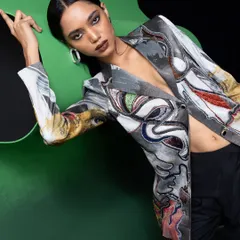 A closer, more dynamic shot from the Advait campaign. The model's pose and expression add energy, while the composition highlights the unique, abstract design of the blazer.