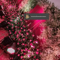 Another angle of detailed floral and lighting work. The pink lights bring out the color of the roses, creating a beautiful carpet of flowers that enhances the venue's ambiance.