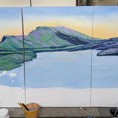 The painting in progress, with the main color blocks for the sky, mountains, and water established. This stage is about building the composition and mood before adding finer details.