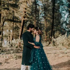 An intimate shot of the couple, highlighting their coordinated outfits in a natural, romantic setting.