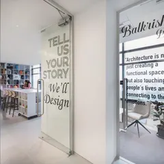 The entrance to our office, featuring our design philosophy on the glass doors: "Tell Us Your Story, We'll Design."