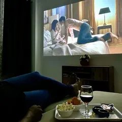A perfect view of the private cinema from the bed. You can enjoy breakfast in bed while watching a movie, with everything you need right there.