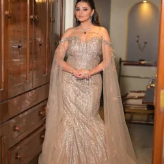 Slaying with a touch of sparkle. This full-length shot showcases how the high-glam makeup and Hollywood waves hairstyle come together with the sequined gown for a truly show-stopping effect.