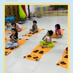 Namaste from India! As part of our 'Around the World' theme, children learn about different cultures. Here, they are enjoying a yoga session, a wonderful way to improve focus and flexibility.