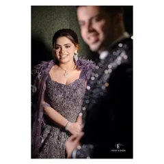 A candid shot of the bride looking towards the groom, her smile radiant, capturing a spontaneous moment of joy during their reception.
