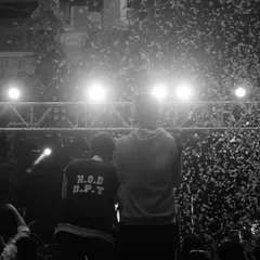 A black and white photo capturing the view from the stage during a confetti drop, showing the scale of the event.