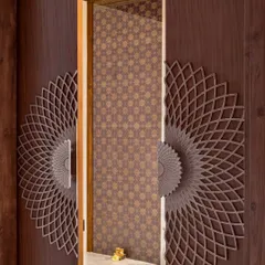 We believe even functional elements like doors should be works of art. For this pooja room, we designed custom door handles with an intricate, mandala-like pattern. The geometric wallpaper inside provides a beautiful, traditional backdrop, creating a serene and spiritual entrance.