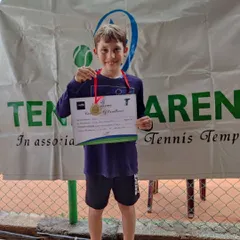 A proud moment for one of our young players, showing off his medal and Certificate of Excellence after competing in the Red and Orange Ball Tournament.