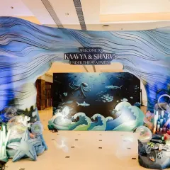 We love creating magical entrances that transport guests to another world. This 'Under the Sea' party entrance features a stunning wave arch and deep-sea backdrop, setting the stage for an aquatic adventure.